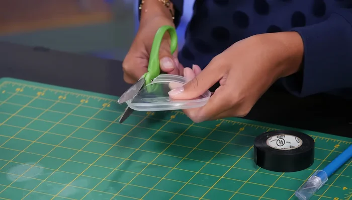 Cut the rim off an extra Pringles lid and cut a hole for the flashlight, securing it with tape.