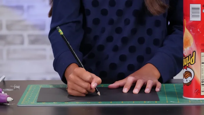 Use double-sided tape to attach the symbol to the inside of the lid, reassemble the can.