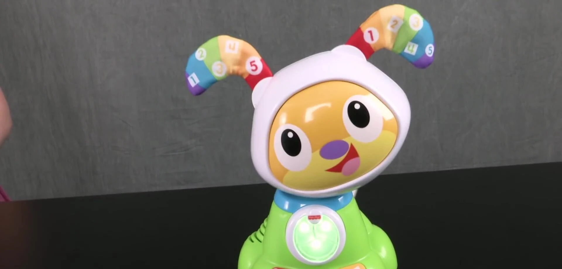 A child interacting with the BeatBowWow toy's buttons.