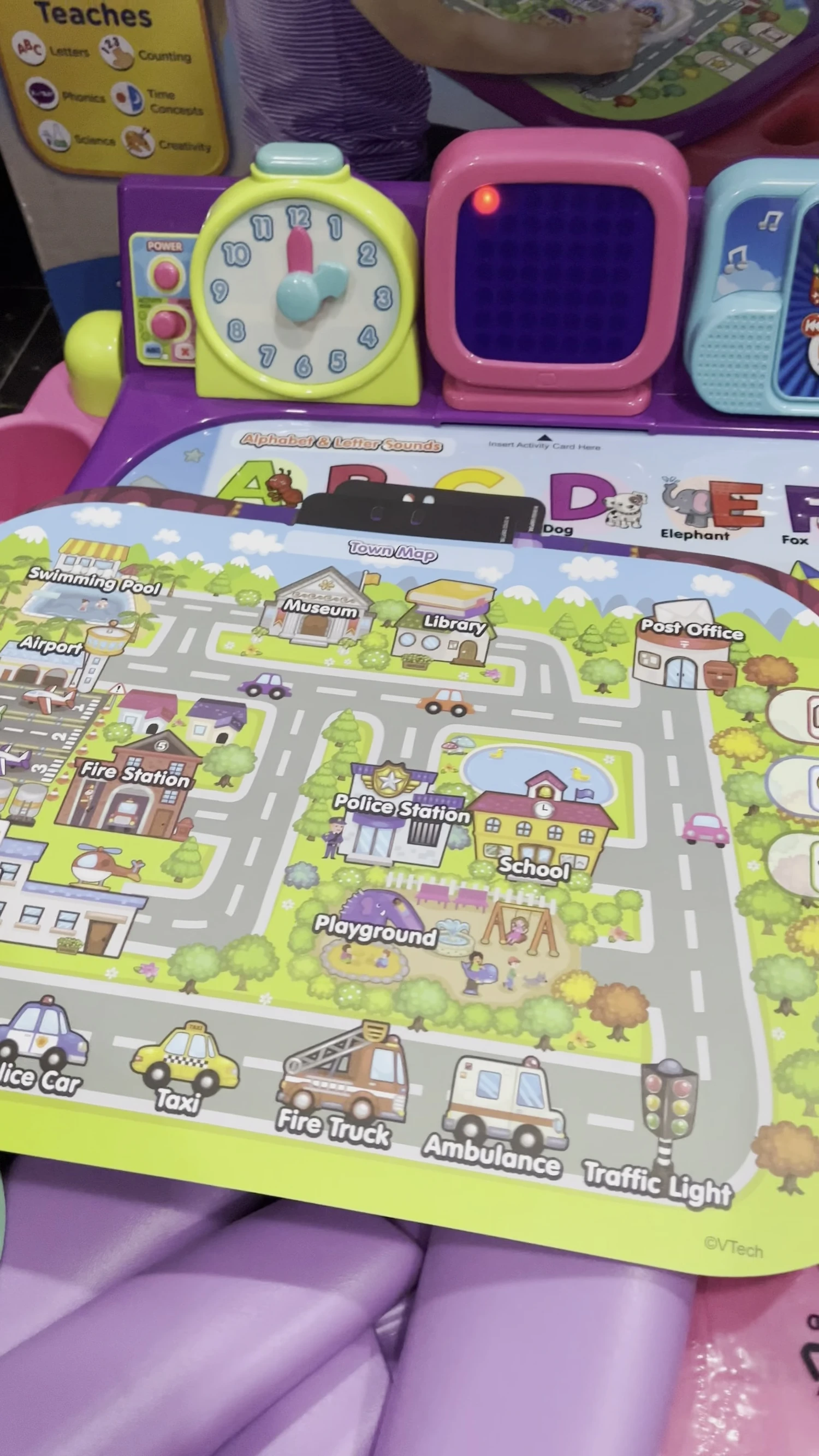 The screen shows a town map, demonstrating broader learning elements.