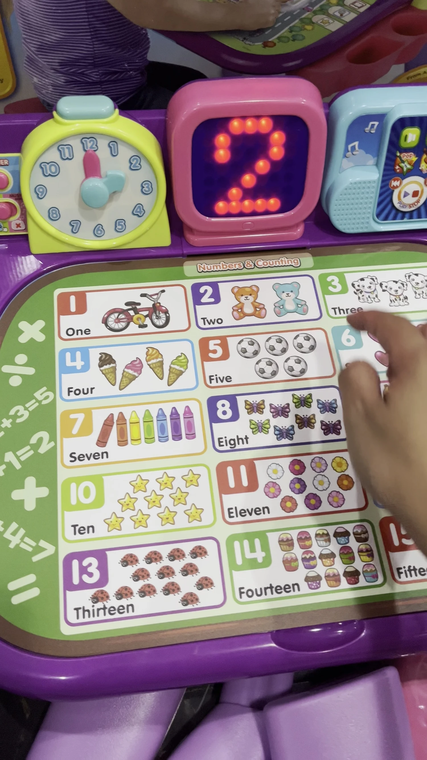 The screen displays numbers and counting exercises.
