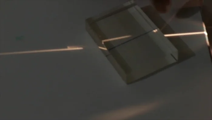 Measure the angles of incidence and refraction using a protractor to calculate the refractive index of the acrylic material.