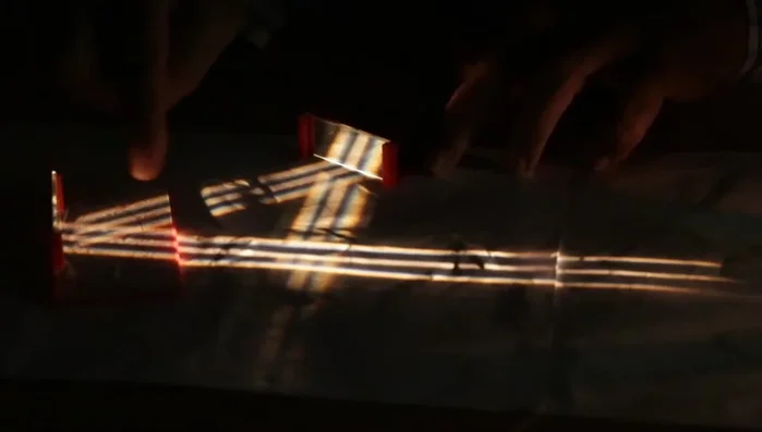 Set up the light source, condensing lens, and plastic plate with three slits to create parallel rays.