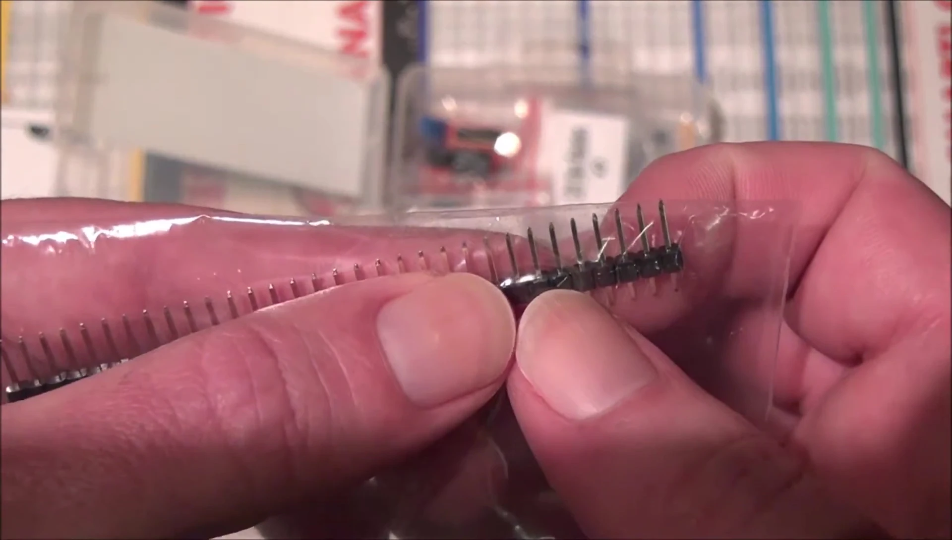 Using needle-nose pliers to break away headers