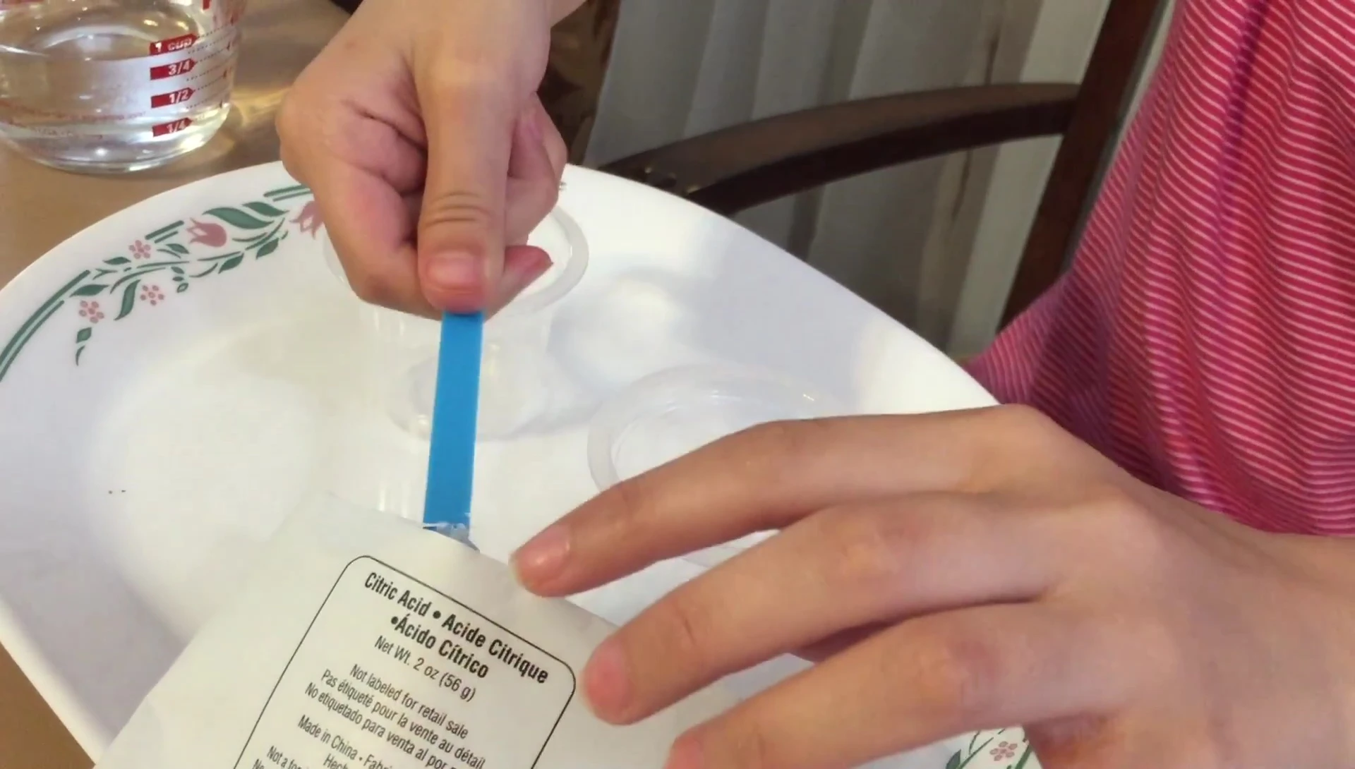 Adding the powders to the water for the Dancing Powders experiment