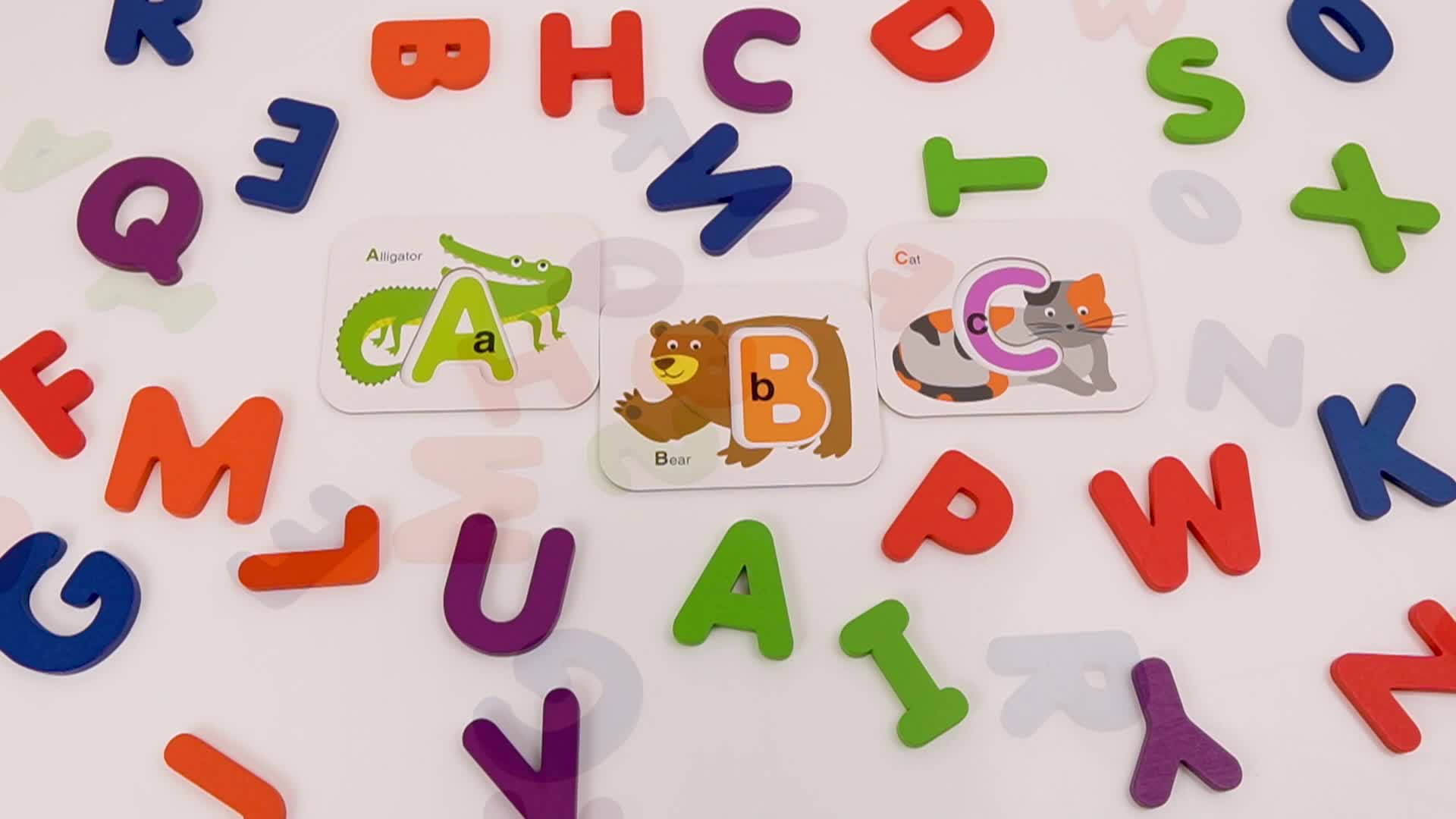 A child discovering a pile of alphabet letter cards.