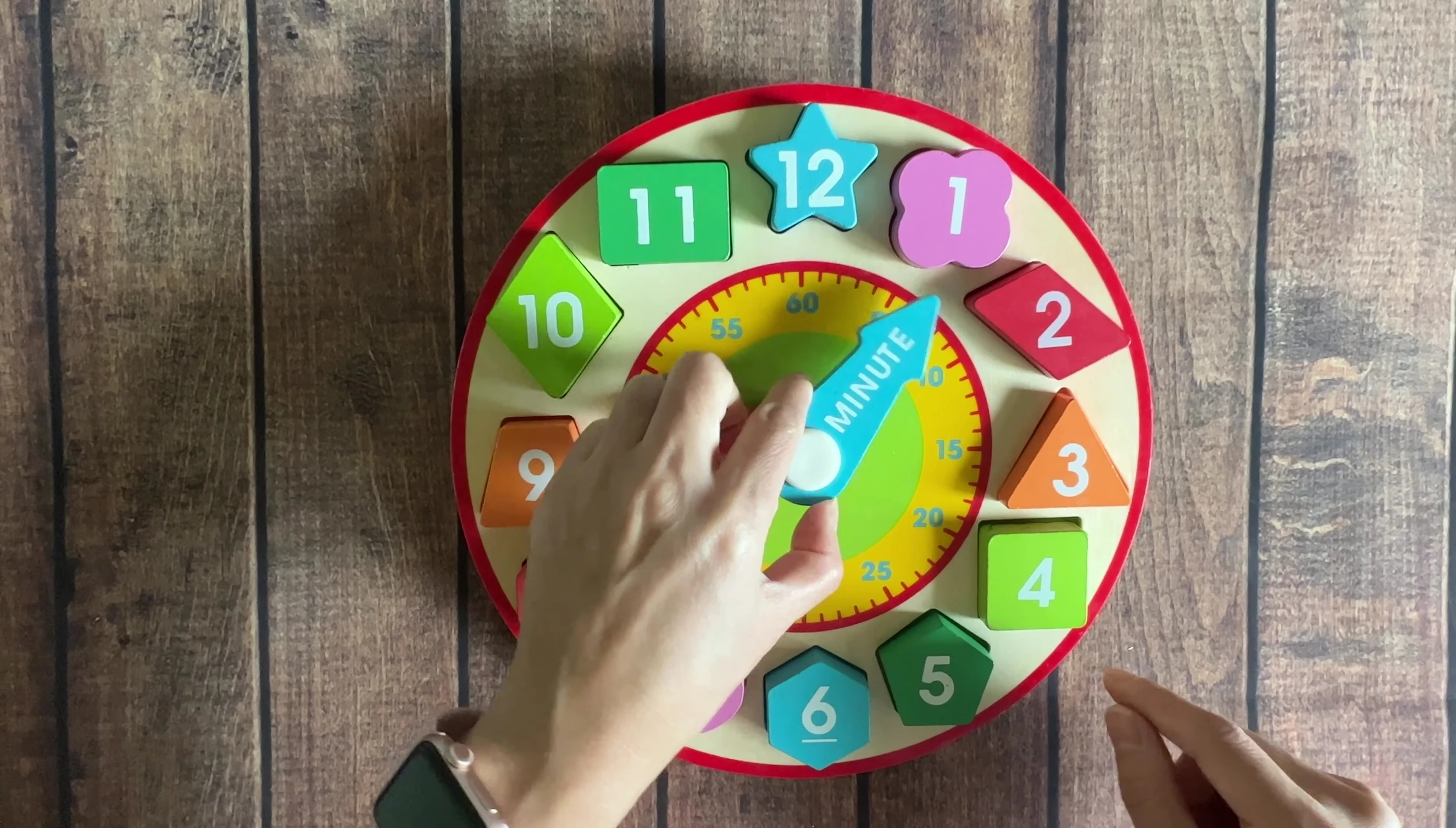 The clock showing the hour and minute hands.