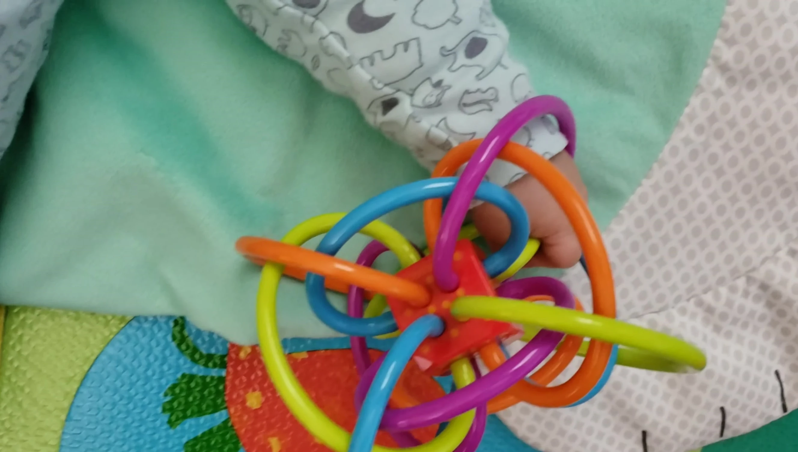 A demonstration of the baby's hand potentially getting tangled in the toy's loops.