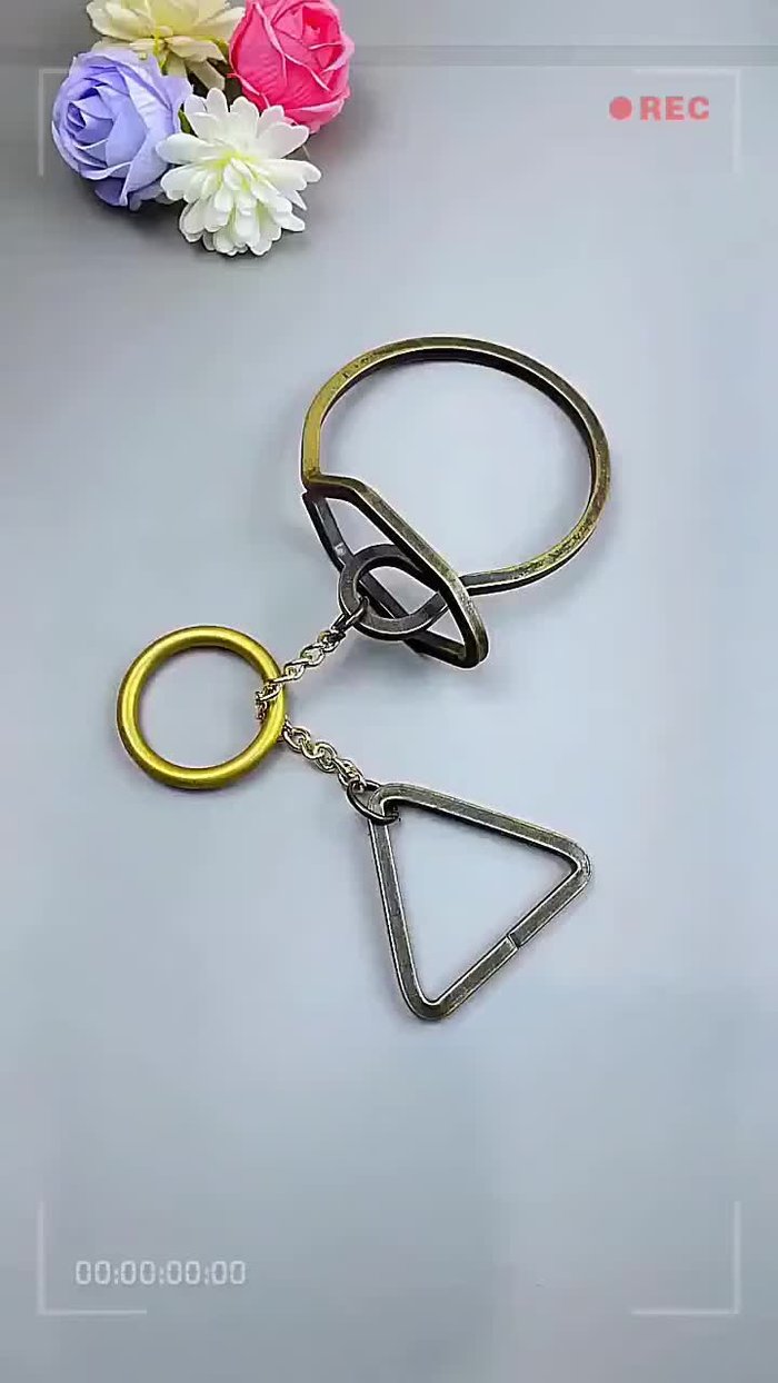 Observe the structure: Notice the triangular ring at the bottom and the closed loop of the gold ring.