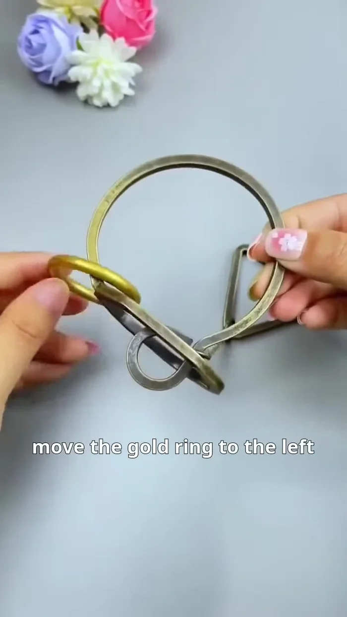 Remove the gold ring: Pass the gold ring downwards through the gap, freeing it from the chain.
