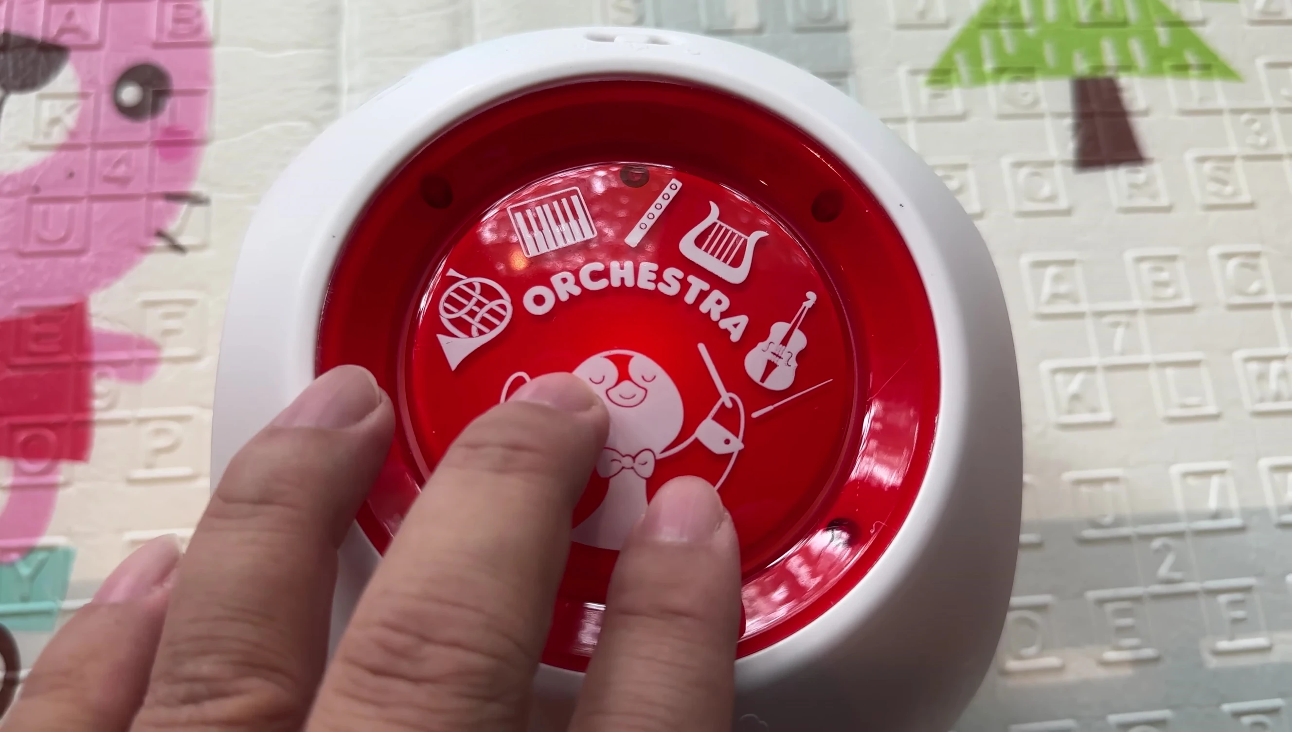 Person pressing the Orchestra button.