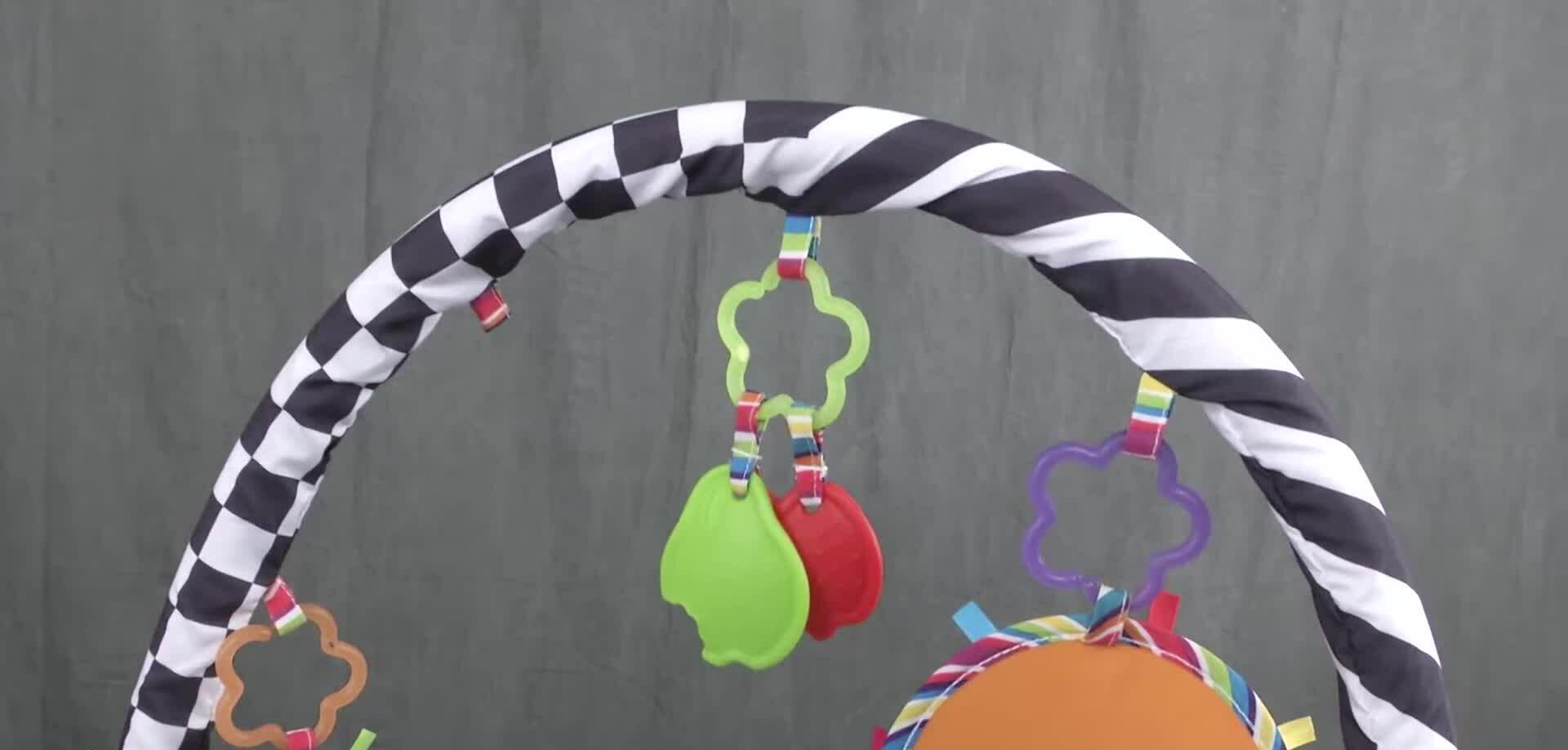 Close-up of the Lamaze Freddie the Firefly Gym showing its three modes of use: lay-and-play, tummy time, and sit-and-play.