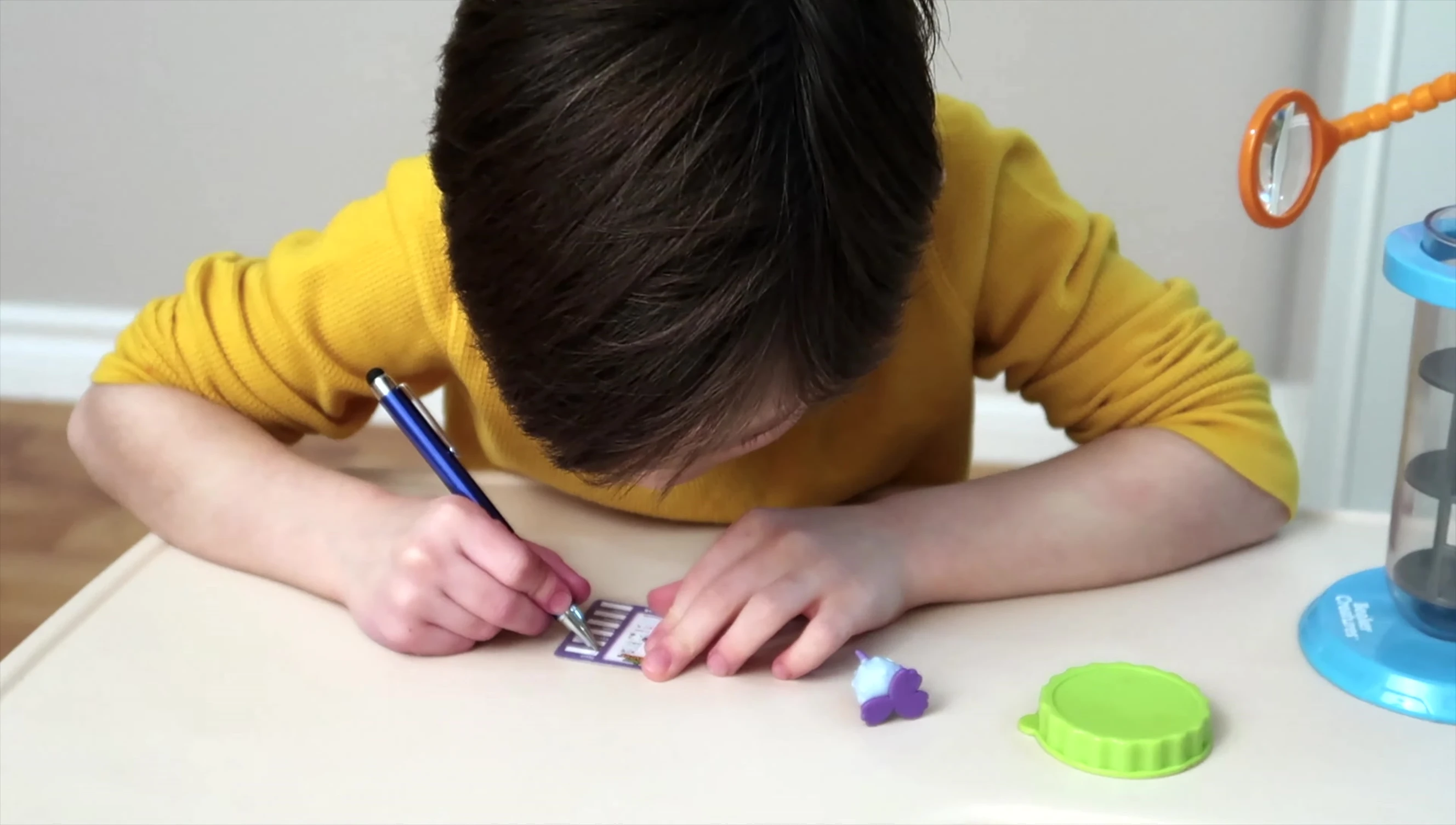 The child recording observations on a sheet.