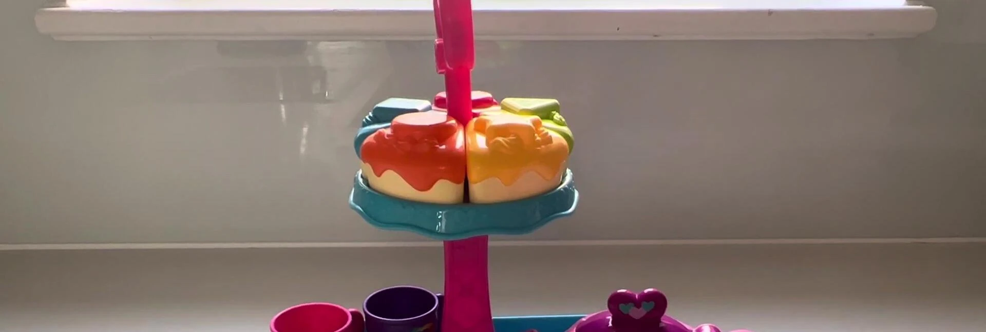 Child demonstrating the pouring action of the teapot