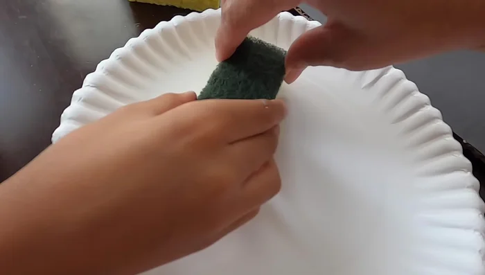 Sponge on blue paint to create a space background on the board.