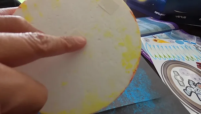 Carefully place the foam balls (planets) onto the board to create your solar system model.