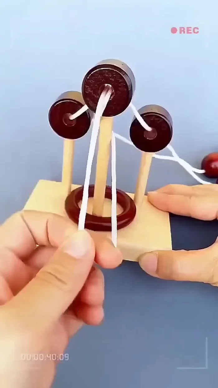 Gently pull the left cord outward and gather it into a single strand.