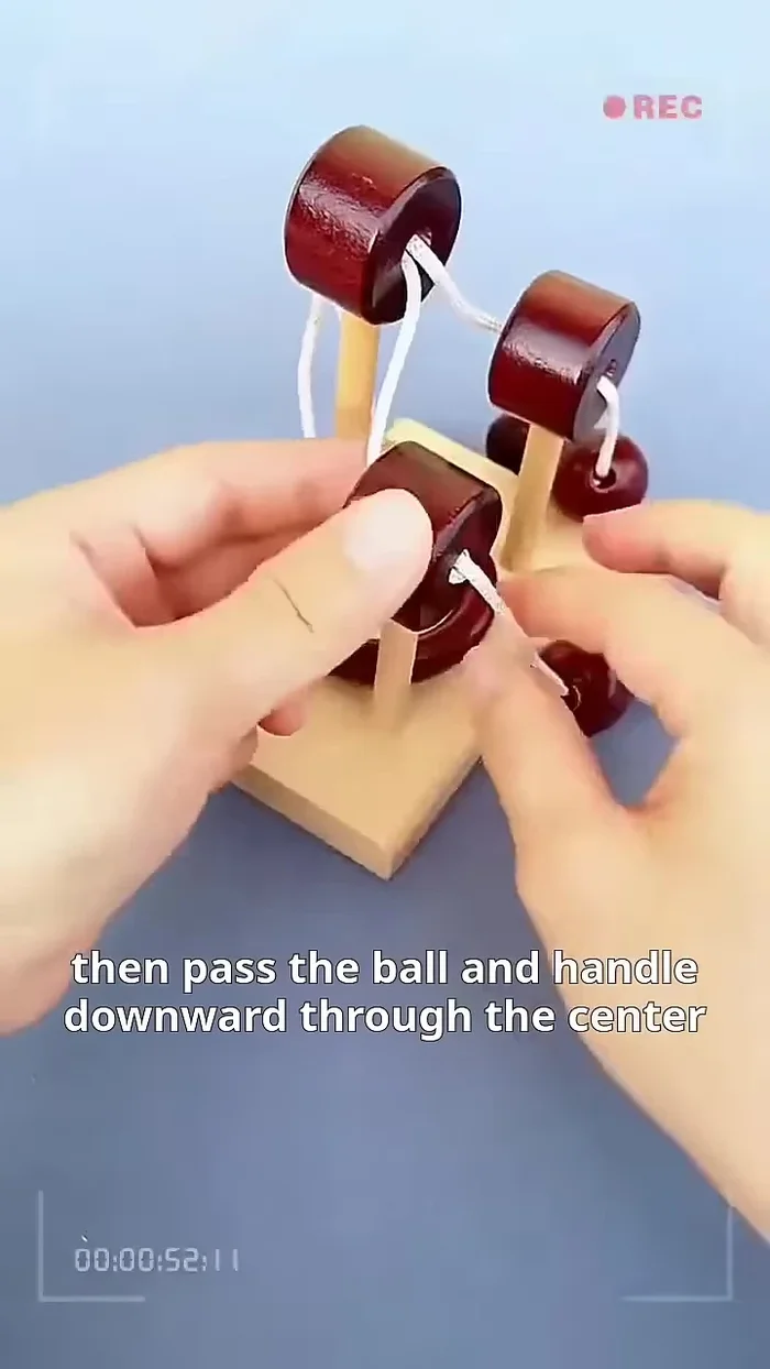 Pull the cord back through, looping it around the central pillar.