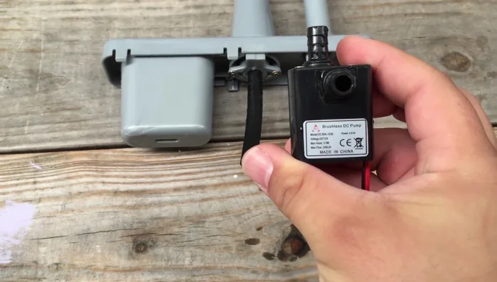 Attach the brushless DC pump to the water basin, ensuring the intake and outlet are correctly positioned.