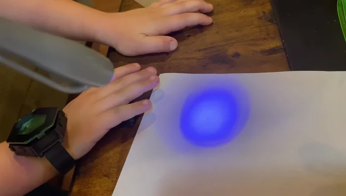 Use the spy gear to reveal secret messages on paper.