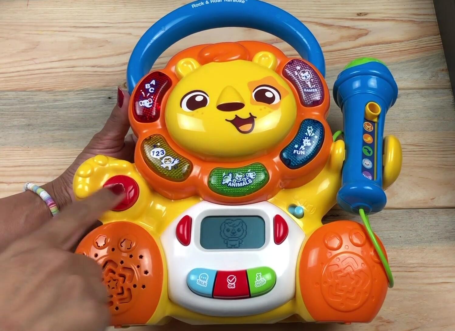 Child happily playing with the karaoke machine