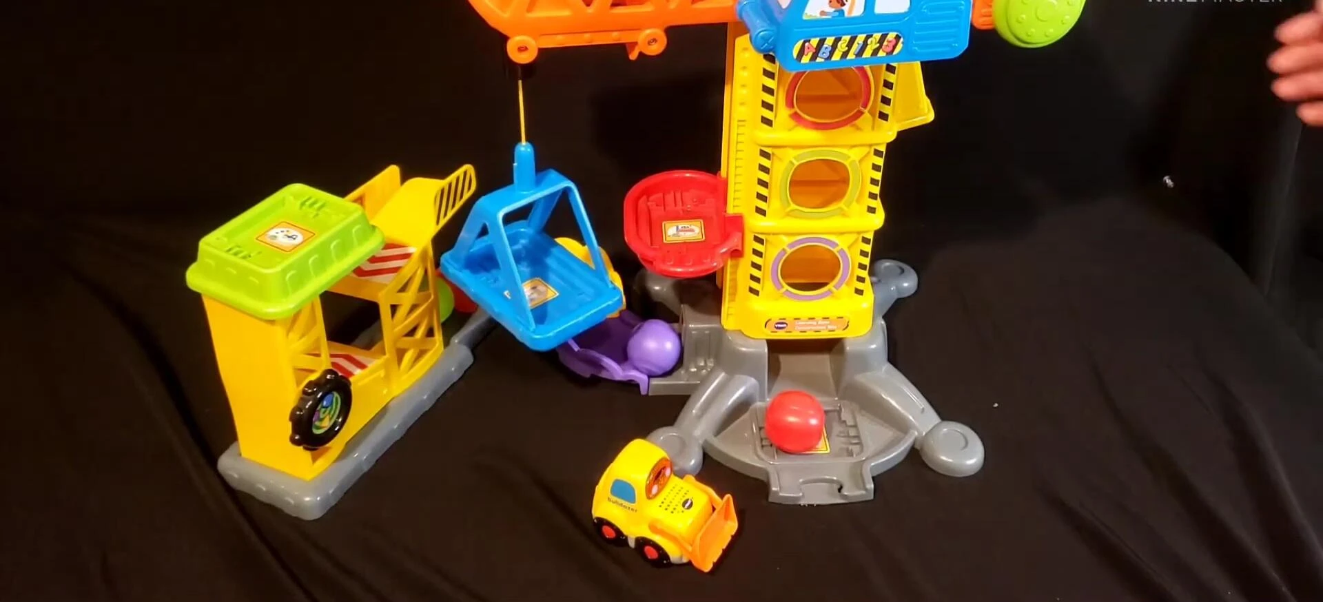 Child interacting with the conveyor belt, highlighting the development of fine motor skills.