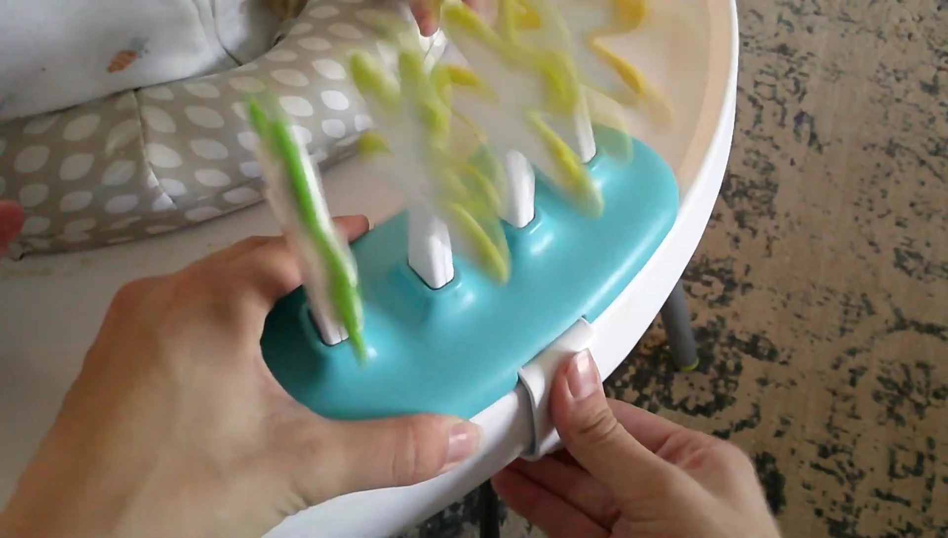Demonstrating how easy it is to remove the clip-on toys