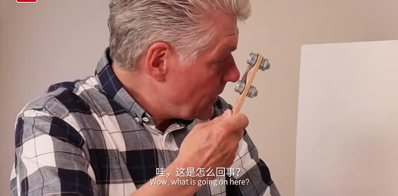 The presenter explaining the science behind the illusion.