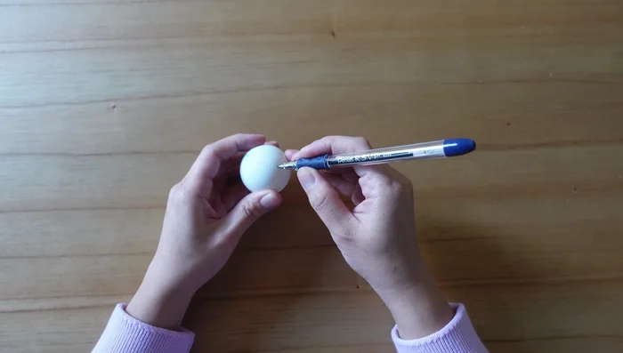 Use a pen to gently enlarge the hole to fit the toothpick.