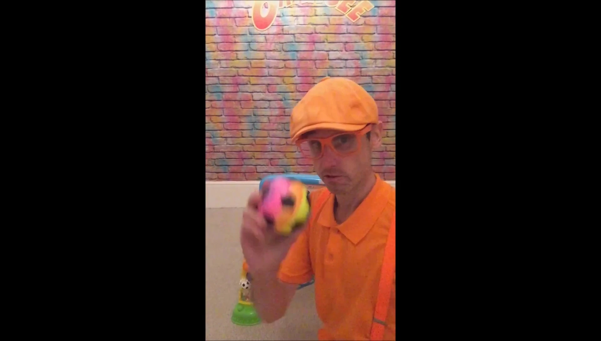 The rainbow soccer ball sitting next to the toy.