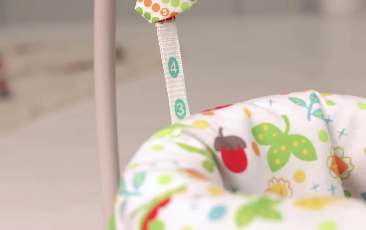 Adjusting the height of the Jumperoo.