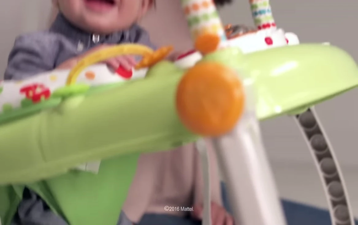 Baby happily playing in the Jumperoo.