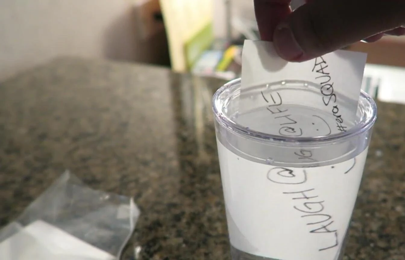 The paper disappearing in water.