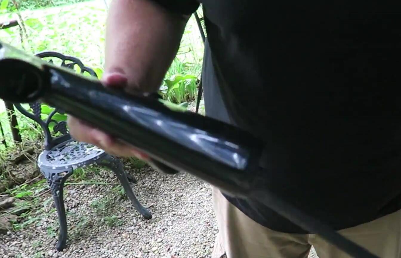 Demonstrating the hidden compartment in the gun.